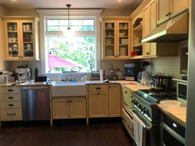a kitchen with a sink and a stove and a window at Stylish Mission-Style Home on Park in Jersey City, NJ in Jersey City