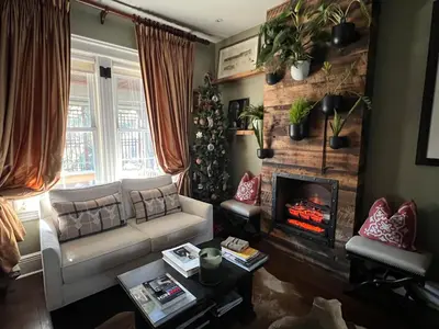 a living room with a couch and a fireplace at Stylish Mission-Style Home on Park in Jersey City, NJ in Jersey City