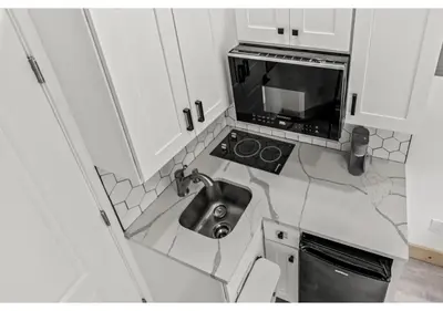 a small kitchen with a sink and a microwave at City Ave GSN Vine 1 in Philadelphia