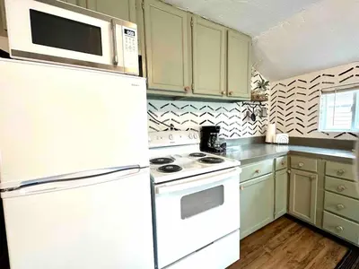 a kitchen with a white stove and a microwave at Boyertown Bungalow Near the Manatawny Creek in Boyertown