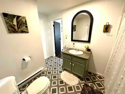a bathroom with a sink and a toilet and a mirror at Boyertown Bungalow Near the Manatawny Creek in Boyertown