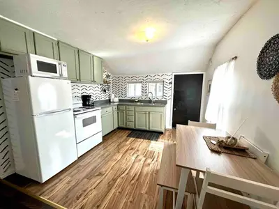 a kitchen with green cabinets and a white refrigerator at Boyertown Bungalow Near the Manatawny Creek in Boyertown