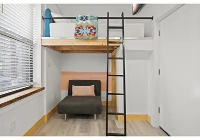 a room with a loft bed and a chair at Center City GSN Vine 2 in Philadelphia