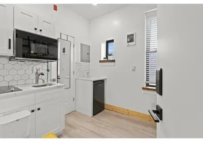 a white kitchen with a sink and a refrigerator at Center City GSN Vine 2 in Philadelphia
