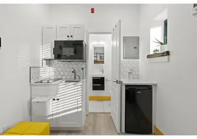 a white kitchen with a sink and a microwave at Center City GSN Vine 2 in Philadelphia