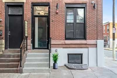 a brick house with a potted plant in front of it at Center City GSN Vine 2 in Philadelphia