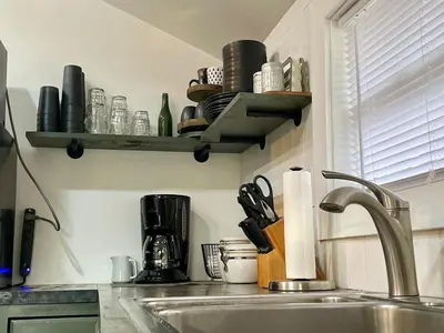 a kitchen with a sink and a counter with a shelf at Fir Lane Lodge Near the Manatawny Creek in Boyertown