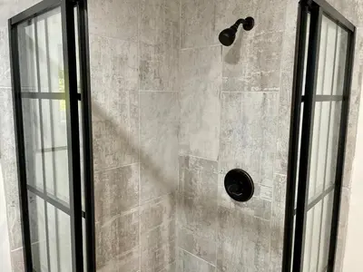a shower with a glass door next to a shower at Fir Lane Lodge Near the Manatawny Creek in Boyertown
