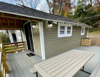 a small house with a bench on a porch at Fir Lane Lodge Near the Manatawny Creek in Boyertown