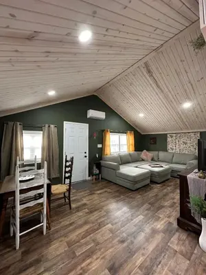 a living room with a couch and a table at Manatawny Creek Cottage in Boyertown