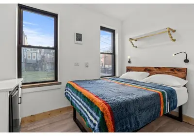 a bedroom with a bed and two windows at Northern Liberties GSN Vine 3 in Philadelphia