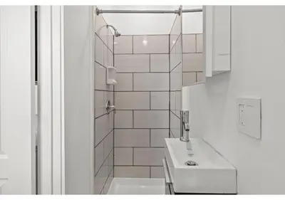 a white bathroom with a sink and a shower at Northern Liberties GSN Vine 3 in Philadelphia