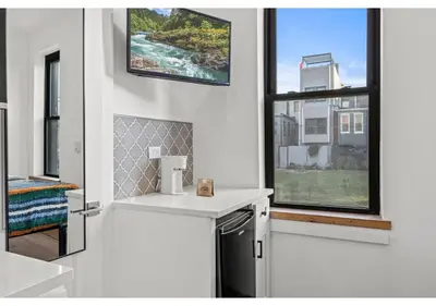 a white kitchen with a sink and a window at Northern Liberties GSN Vine 3 in Philadelphia