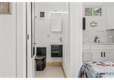 a small white kitchen with a sink and a bed at Temple University GSN Vine 4 in Philadelphia
