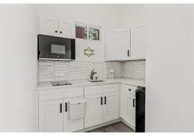 a white kitchen with a sink and a microwave at Temple University GSN Vine 4 in Philadelphia