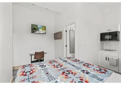 a white room with a bed and a kitchen at Temple University GSN Vine 4 in Philadelphia