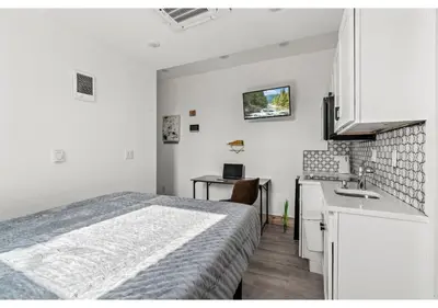a white bedroom with a bed and a sink at Center City Philadelphia GSN Bloom 1 in Philadelphia