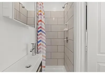 a bathroom with a sink and a shower curtain at Temple District GSN Bloom3 in Philadelphia