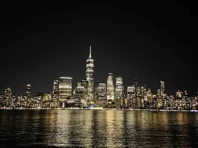 a night view of a city with the skyscrapers at VAN VORST HOUSE Prime Location Minutes to NYC in Jersey City
