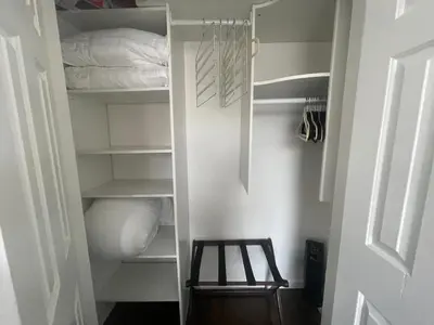 a closet with a wooden stool in a room at Perfect for Extended Stay 1B1B Apt 15 Mins to NYC in Jersey City