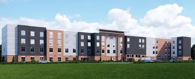 a rendering of a building with a field in front at Hyatt House Monroe / Cranbury / South Brunswick in Monroe Township