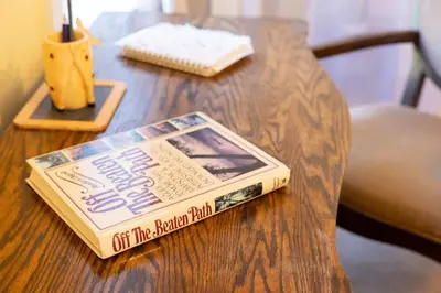 a book sitting on top of a wooden table at Private 2-Bedroom Second-Floor Residence, Bala Cynwyd in Bala-Cynwyd
