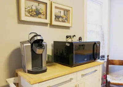 a microwave sitting on top of a wooden cabinet with a microwave at Private 2-Bedroom Second-Floor Residence, Bala Cynwyd in Bala-Cynwyd