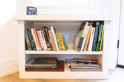 a white book shelf filled with books at Private 2-Bedroom Second-Floor Residence, Bala Cynwyd in Bala-Cynwyd