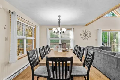 a dining room with a table and chairs at Cozy Poconos Chalet Sauna, Hot Tub, Game Room in Albrightsville