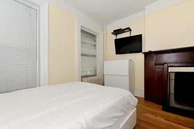 a bedroom with a bed and a flat screen tv at Comfy 3 Bedroom 2 Bath Apartment in NYC in New York