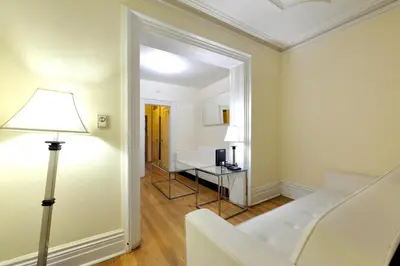 a living room with a white couch and a table at Comfy 3 Bedroom 2 Bath Apartment in NYC in New York