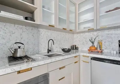 a kitchen with white cabinets and a sink at Alluring and Spacious 1 Bed 1 Bath Apt in New York
