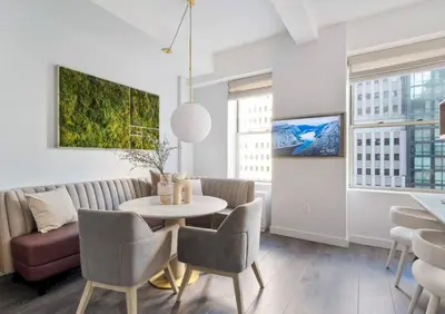 a living room with a table and chairs and a couch at Alluring and Spacious 1 Bed 1 Bath Apt in New York