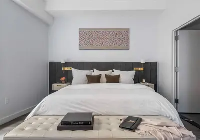 a bedroom with a large bed with two books on it at Alluring and Spacious 1 Bed 1 Bath Apt in New York