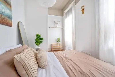 a bedroom with a bed and a window at Bright and Beautiful 3 BR Apt Midtown West in New York