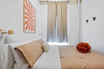 a bedroom with a bed with an orange stuffed animal on it at Bright and Beautiful 3 BR Apt Midtown West in New York