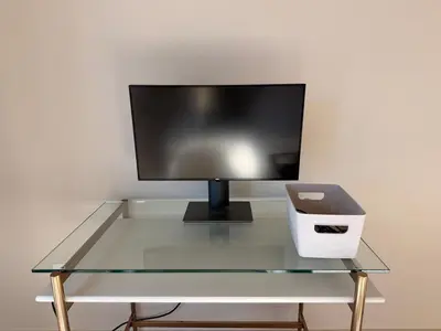 a glass table with a computer monitor and a printer at Luxury Catskills Sauna Retreat -Haven On The Manor in Livingston Manor
