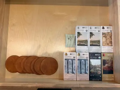 a wooden shelf with books and a bottle of wine at Luxury Catskills Sauna Retreat -Haven On The Manor in Livingston Manor