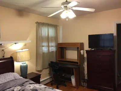 a bedroom with a bed and a flat screen tv at Fully furnished unit for rent in Wilmington