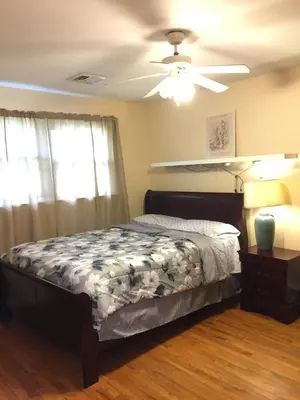 a bedroom with a bed and a ceiling fan at Fully furnished unit for rent in Wilmington
