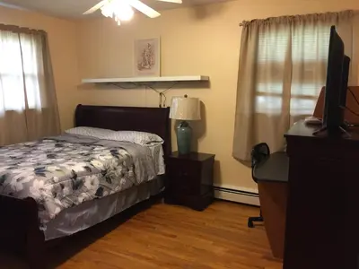 a bedroom with a bed and a television in it at Fully furnished unit for rent in Wilmington
