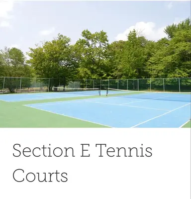 two people playing tennis on a tennis court at Cozy Cabin in Tobyhanna