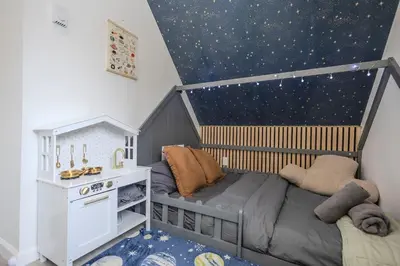 a childs bedroom with a crib and a star ceiling at Summit Home - The Ultimate Summit of Style for 12 in Tobyhanna