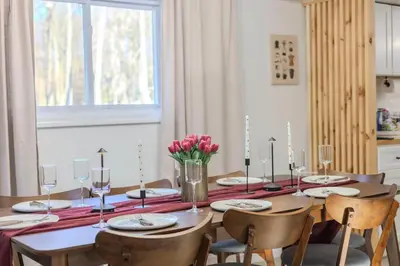 a dining room table with chairs and a table with candles at Summit Home - The Ultimate Summit of Style for 12 in Tobyhanna