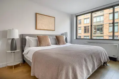 a bedroom with a large bed and a window at Chelsea 1br w doorman wd nr West Village NYC-1385 in New York