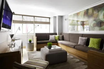 a living room with a couch and a tv at Chelsea 1br w doorman wd nr West Village NYC-1385 in New York
