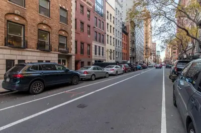a city street with cars parked on the side of the road at Chelsea 1br w doorman wd nr West Village NYC-1385 in New York