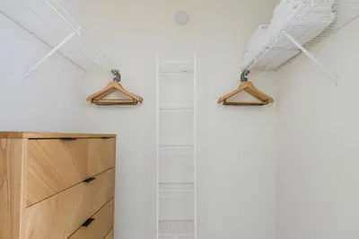 a room with wooden cabinets and a white wall at Blueground Hudson Exchange pool nr Liberty Park NYC-1890 in New York