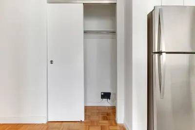 a kitchen with a stainless steel refrigerator in a room at Blueground Hells Kitchen washer nr Times Square NYC-2074 in New York