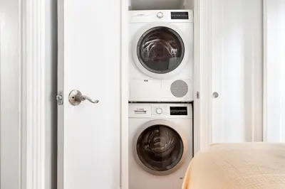 two washing machines and a washer and dryer in a room at Blueground West Village terrace nr Hudson River Park NYC-2123 in New York